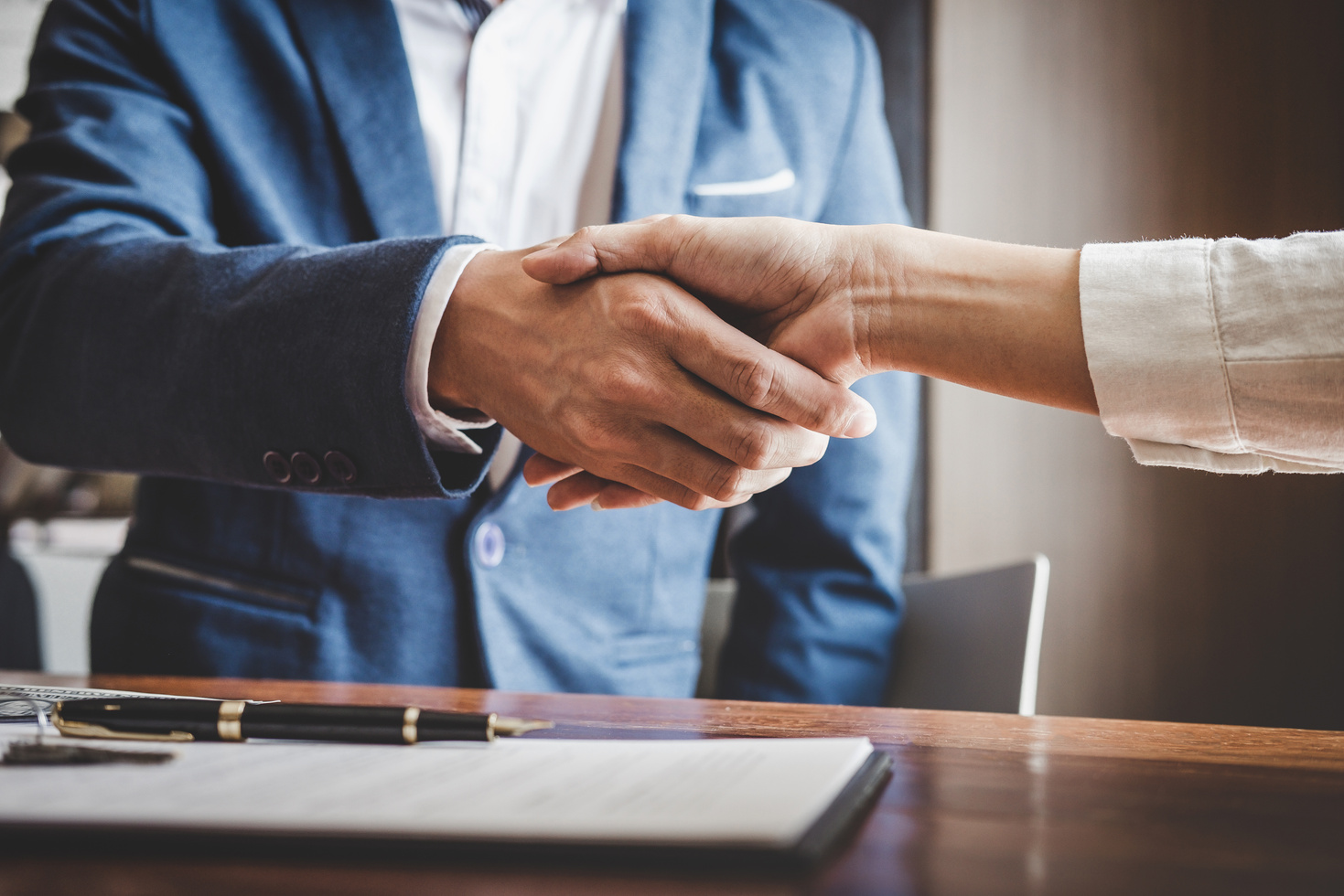 Real Estate Agent and Customers Shaking Hands